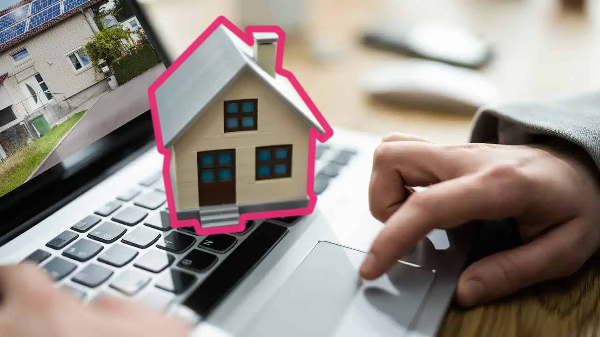 hands on a laptop with a house on top