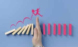 man jumping over a hand