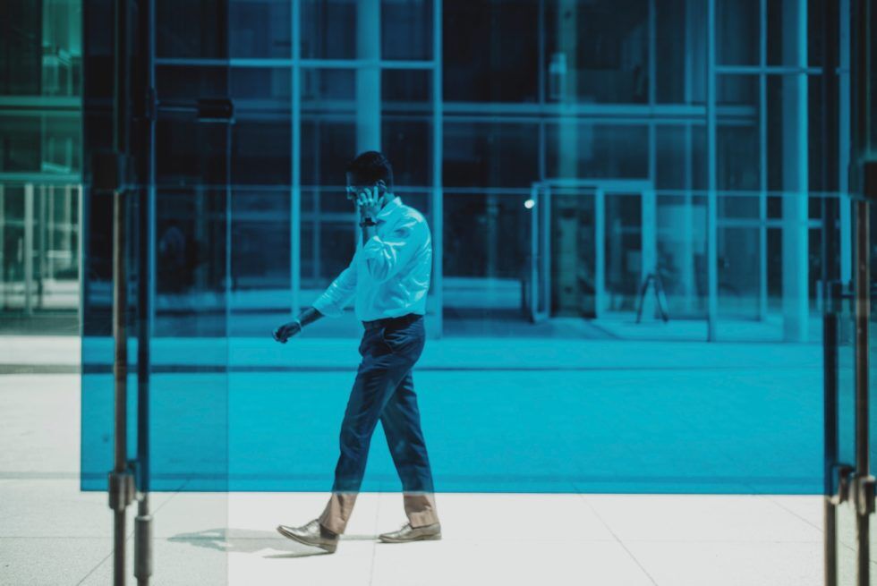 man walking talking to phone