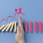 man jumping over a hand